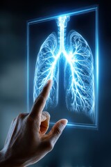 Hand pointing at glowing X-ray image of human lungs on digital screen