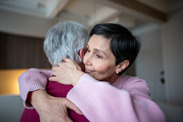 Close up of calm joyful senior wife embracing husband lovingly. Family support care, emotional assistance, healthy long term bonding in retired couple, enduring partnership through crisis, trust care