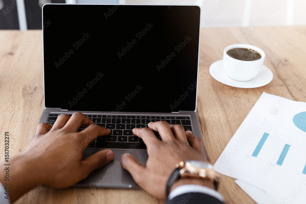 Poster unrecognizable african american businessman typing on small modern laptop keyboard with empty screen