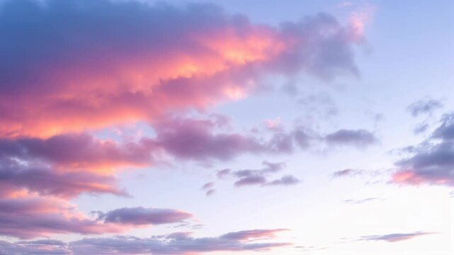 Pastel blue sky with soft pink cloud floating during twilight hour creating dreamy atmosphere. Gentle weather transition. Use for wellness and relaxation content