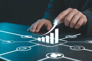 Hand interacting with futuristic digital interface showing upward bar graph and connected data analytics icons in blue technology style

