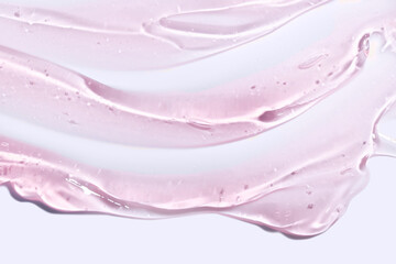 Cream gel drops red transparent cosmetic sample texture with bubbles on pink background