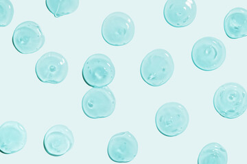 Liquid gel cosmetic drops texture blue grey background. Cosmetic skin care beauty product