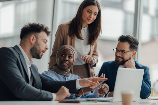 Business people working together on laptop in modern office