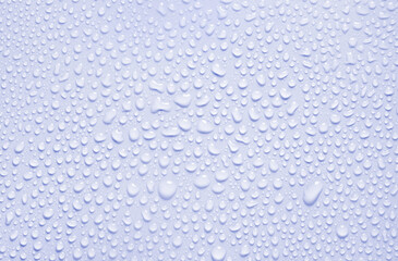 Cosmetic moisturizing liquid drops on blue pastel background. Toner or lotion. Hyaluronic serum