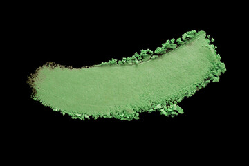 Eye shadow emerald green crushed powder smudged isolated on black. Make up beauty product brush stroke smudge