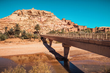 Concrete bridge crossing a river leading to the ancient fortified city of Ait Benhaddou, a World...