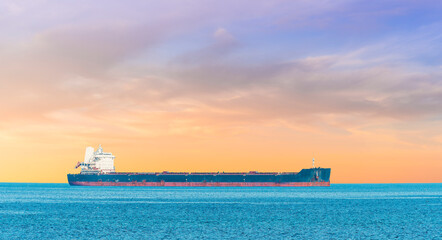 oil tanker ship transporting oil or petroleum in blue sea with clouds.