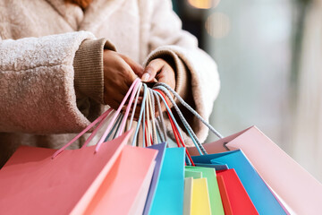Time For Shopping Concept. Closeup of unrecognizable black female customer holding many colorful...