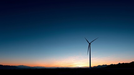 Obraz premium Wind turbine against sunset sky, symbolizing clean energy and sustainable future