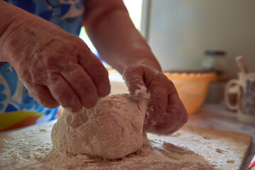 Fototapeta premium Female hands and dough. Making bread.