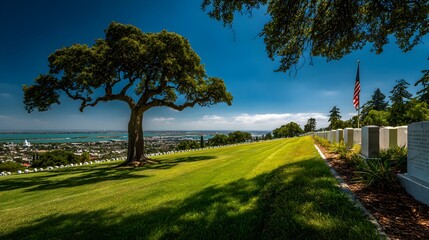 A majestic oak tree stands sentinel over a serene military cemetery overlooking a picturesque coastal city on a bright sunny day.