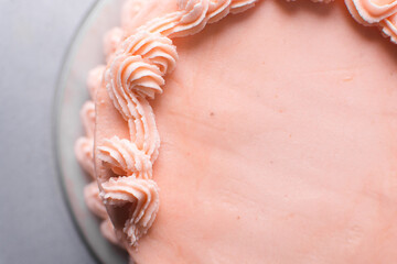 piping border on Pink buttercream cake on a cake plate, Cake covered in pink frosting, process of decorating a cake with pink buttercream