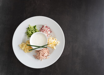 Ready to serve tasty okroshka on dark gray background