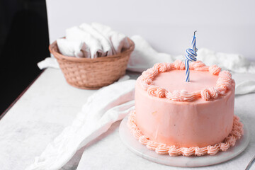 Pink buttercream cake on a cake plate, Cake covered in pink frosting, process of decorating a cake with pink buttercream
