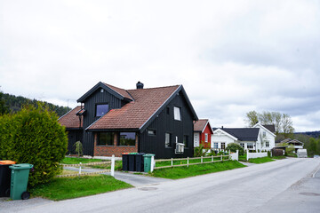 Modern Scandinavian black wooden house with brick and tiled roof in Norway