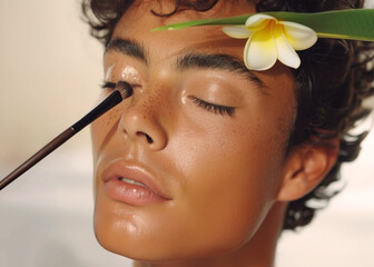 Close up  portrait of gay man applying makeup in front of mirror