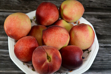 The peach fruit (Prunus persica), a deciduous tree first domesticated and cultivated in China, edible juicy fruits, most called peaches and the glossy-skinned, non-fuzzy varieties called nectarines