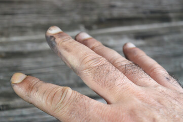 a hand with automotive oil and grease, car maintenance concept, mechanic workshop, hand with dirt after car services, oil grease dirt on fingers of a hand, selective focus
