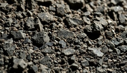 pile of black rocks sitting on top of a pile of dirt