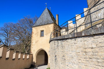 Historic stone castle tower and walls with arched entrance in architectural landscape