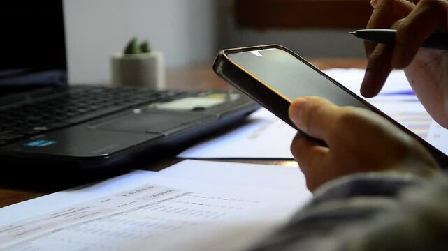 A woman looks for price references on her smartphone and then checks them on her worksheet.
To-Do List and Task List Concept. Close-up businessman checks or marks with pen on a checklist