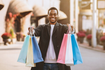 Beginning of sales season and Black Friday for shopaholic before holidays. Happy millennial african...