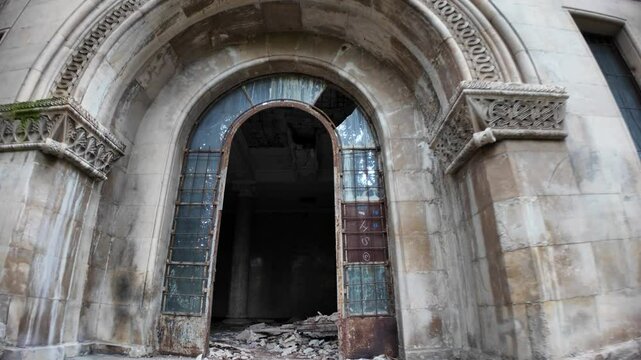 Showing the decaying entrance of the Sanatorium Metallurgist, a Soviet-era spa resort in Tskaltubo, Georgia, highlighting the effects of time and neglect on architectural grandeur