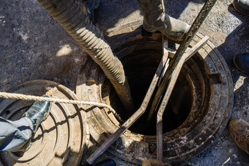 Process of cleaning up sewage collector. Pumping out household septic tank