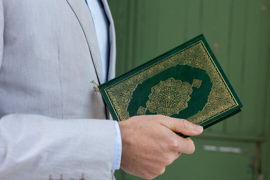 man holding green book