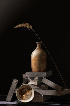 Still life with different textures of marble, ceramics and dried grass