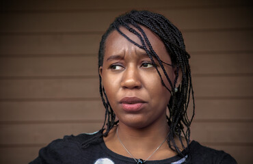 Worried African Woman Looking Sideways with Disgusted Anxiety Expression