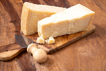 Traditional italian food, 36 months aged in caves Italian parmesan hard cheese from Parmigiano-Reggiano and grana padano from Po river valley, Italy