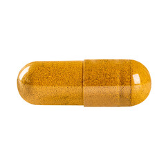 Close up. Turmeric capsule isolated on white background. Exotic herb capsule