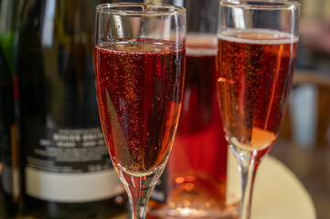 Pouring and tasting of rose or pink cuvee sparkling wine brut, grand reserve, champagne in Ay-Champagne wine making village in Vallee de la Marne, , Champagne region, France