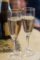 Pouring and tasting of dry sparkling wine brut, grand reserve, champagne in Ay-Champagne wine making village in Vallee de la Marne, , Champagne region, France