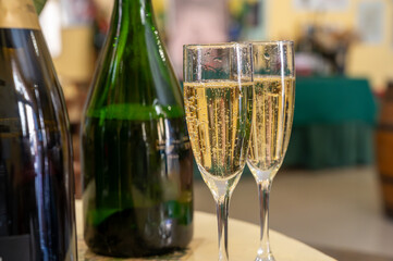 Pouring and tasting of dry sparkling wine brut, grand reserve, champagne in Ay-Champagne wine making village in Vallee de la Marne, , Champagne region, France