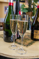 Pouring and tasting of dry sparkling wine brut, grand reserve, champagne in Ay-Champagne wine making village in Vallee de la Marne, , Champagne region, France