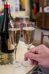 Pouring and tasting of dry sparkling wine brut, grand reserve, champagne in Ay-Champagne wine making village in Vallee de la Marne, , Champagne region, France