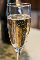Pouring and tasting of dry sparkling wine brut, grand reserve, champagne in Ay-Champagne wine making village in Vallee de la Marne, , Champagne region, France
