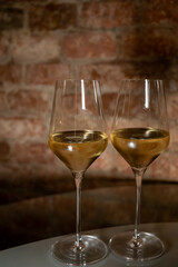 Visit of wine cellar, tasting of brut champagne sparkling wine produced by traditional method in underground caves close up