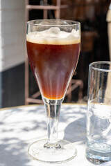 Belgian beer in glass in old brewery in Bruges, dubbel dark, tasty beverage, lunch with beer, tourist destination, Flanders, Belgium