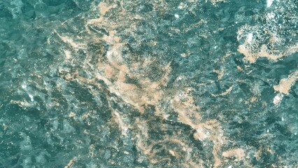 Drone captures the disturbing sight of microplastics floating on the water's surface, a stark reminder of the long-lasting impact of pollution on marine ecosystems.
