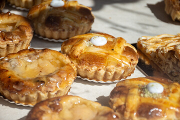 Fresh baked buttered fruit and sweet buns, cakes, pastries in artisan bakery early morning in Bruges, Belgium