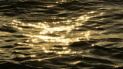 The drone captures a mystical scene where golden light radiates off the ocean’s surface, transforming the water into a breathtaking spectacle of color and light.

