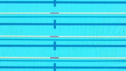 An aerial shot of the pool’s lanes highlights the precise and organized lines that define the space, ideal for competitive swimmers training in a controlled, efficient environment.
