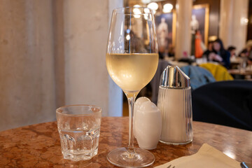 Lifestyle of beautiful Vienna, glass of cold white dry Austrian wine served in old Viennese-style...