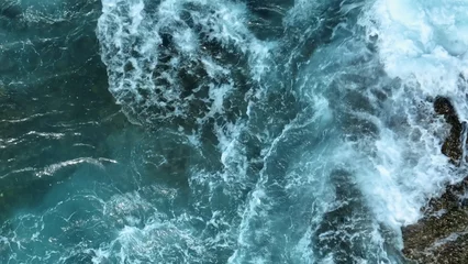 Fotobehang Slaapkamer In slow motion, the ocean erupts against the rocks in an epic display of water and foam, capturing the vastness and unstoppable energy of the ocean as it collides with the shore.   © Punyawee