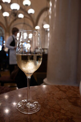 Lifestyle of beautiful Vienna, glass of cold white dry Austrian wine served in old Viennese-style cafe in Vienna, Austria