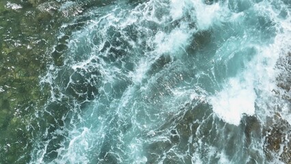 The slow-motion view showcases the ocean's monumental waves, crashing with incredible force,...